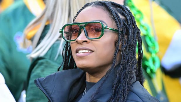 USA gymnast Simone Biles looks on while attending a Green Bay Packers game as a fan.